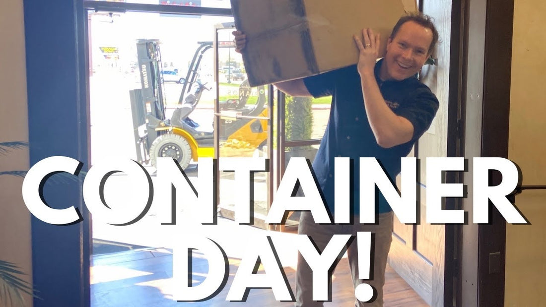 Brigham Larson carries a large box over his shoulder into the shop. Title reads "Container Day!"